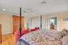 Bedroom with multiple closets, crown molding, light wood-style floors, recessed lighting, and a ceiling fan