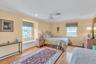 Bedroom featuring ceiling fan, light wood-type flooring, ornamental molding, and recessed lighting