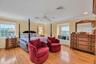 Bedroom featuring crown molding, light wood-style floors, and ceiling fan