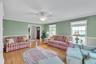 Living area featuring ornamental molding, wood finished floors, and ceiling fan