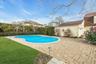 View of swimming pool with a yard and a patio area