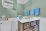 Bathroom featuring ornamental molding, a wainscoted wall, and vanity