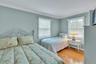 Bedroom with ornamental molding and light wood finished floors