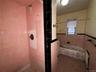 Full bathroom featuring a wainscoted wall, tile walls, tiled shower, and a bathtub