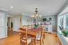 Dining area with ornamental molding, light wood-type flooring, recessed lighting, and a chandelier