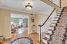 Stairway featuring wood finished floors, crown molding, and ceiling fan