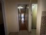 Corridor with light tile patterned flooring
