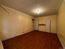 Spare room featuring dark wood-style flooring and ornamental molding