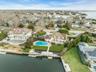 Aerial view of property's location featuring a large body of water and nearby suburban area