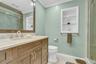 Full bath featuring a marble finish shower, ornamental molding, vanity, light tile patterned flooring, and recessed lighting