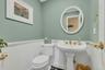 Half bathroom featuring wainscoting