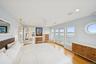 Bedroom featuring access to exterior, light wood finished floors, recessed lighting, ceiling fan, and a water view