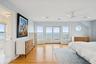 Bedroom with a water view, access to outside, light wood finished floors, a ceiling fan, and recessed lighting