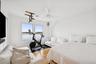 Bedroom featuring wood finished floors, a water view, and ceiling fan