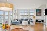 Living room featuring a water view, light wood-style flooring, plenty of natural light, and recessed lighting