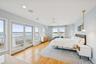 Bedroom with a water view, light wood finished floors, access to outside, recessed lighting, and ceiling fan