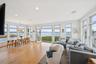 Living room with a water view, light wood-style floors, plenty of natural light, and recessed lighting