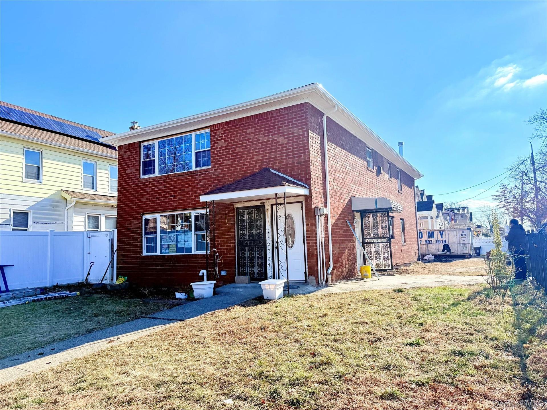 View of front facade featuring brick siding