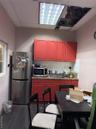 Kitchen featuring fridge, a drop ceiling, wood finished floors, backsplash, and dark countertops