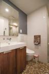 Bathroom with vanity, tile walls, heated spa-like flooring and a shower