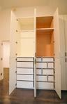 Large custom designed closet extending well over 7-8 feet tall. 2 of 3 cabinets are shown open.