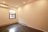 Bedroom with a wall mounted air conditioner, dark wood-style flooring, baseboard heating, and recessed lighting