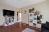 Game room with wood finished floors, arched walkways, and baseboards