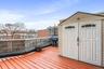 Wooden terrace with grilling area and a shed