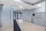 Lobby with a decorative wall, crown molding, and a wainscoted wall