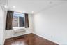 Empty room with dark wood finished floors, an AC wall unit, a wall mounted AC, and recessed lighting