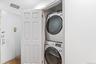 Laundry room with stacked washing machine and dryer