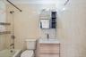 Full bathroom featuring vanity, bathtub / shower combination, and tile walls
