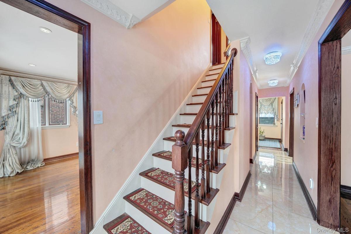 Staircase with baseboards and ornamental molding