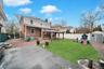 Back of property featuring a patio area, a gazebo, a playground, a fenced backyard, and brick siding