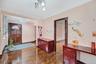 Entryway with ornamental molding, wood-type flooring, and a chandelier