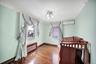 Bedroom with dark wood-type flooring, a wall mounted AC, and ornamental molding