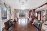Dining area with crown molding, stairs, and a chandelier