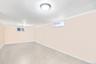 Basement featuring baseboards and ornamental molding