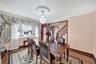 Dining area featuring ornamental molding, wood finished floors, stairway, and a chandelier
