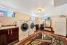 Laundry area with washer and dryer and light wood-style flooring