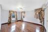 Spare room featuring dark wood finished floors, a wall unit AC, and ornamental molding