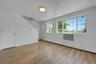 Empty room with light wood-style floors and baseboard heating