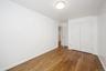 Unfurnished bedroom featuring dark wood-style flooring and a closet