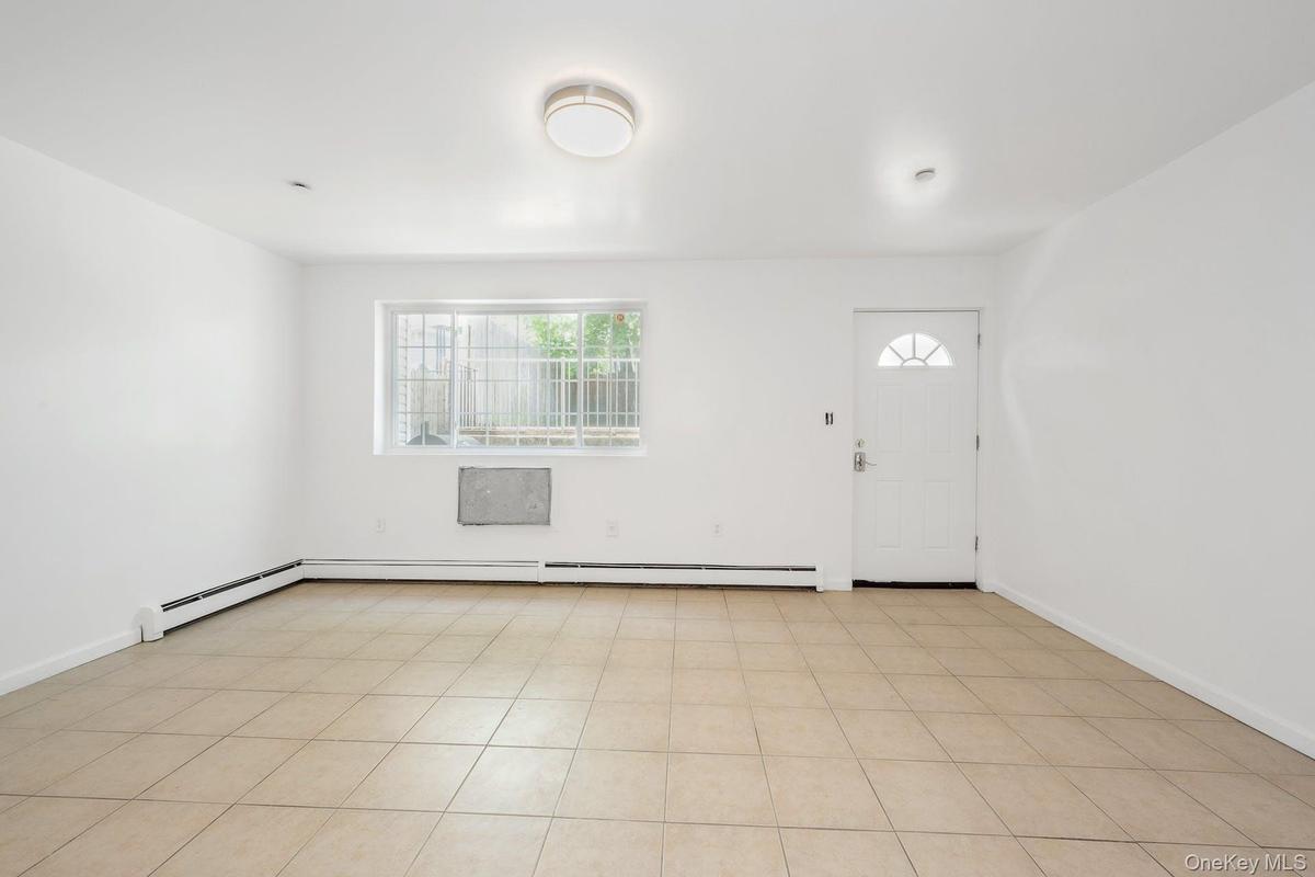 Foyer entrance with baseboards and baseboard heating