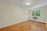 Empty room with baseboard heating and light wood-style flooring