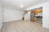 Kitchen featuring appliances with stainless steel finishes, a baseboard heating unit, and brown cabinetry