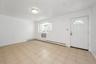 Foyer with a baseboard radiator and light tile patterned flooring