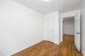Unfurnished bedroom with baseboards and wood finished floors