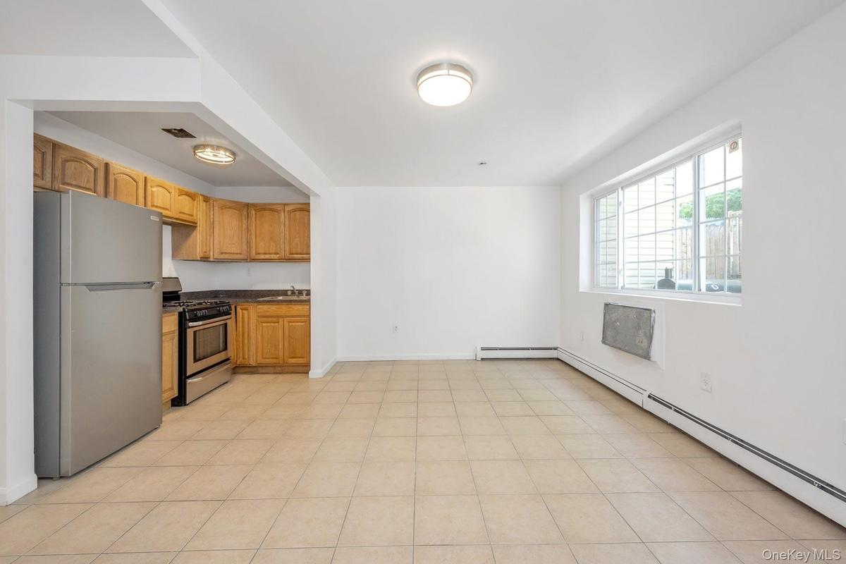 Kitchen featuring stainless steel appliances and baseboard heating