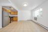 Kitchen featuring stainless steel appliances and baseboard heating